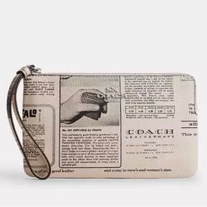 COACH LARGE CORNER ZIP WRISTLET WITH NEWSPAPER PRINT